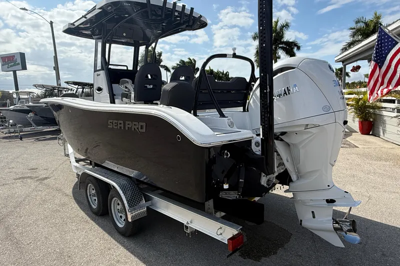 Slide: The Image of 2025 Sea Pro 245FLX Sandbar boat on trailer, featuring Yamaha engine, parked outdoors. - 10
