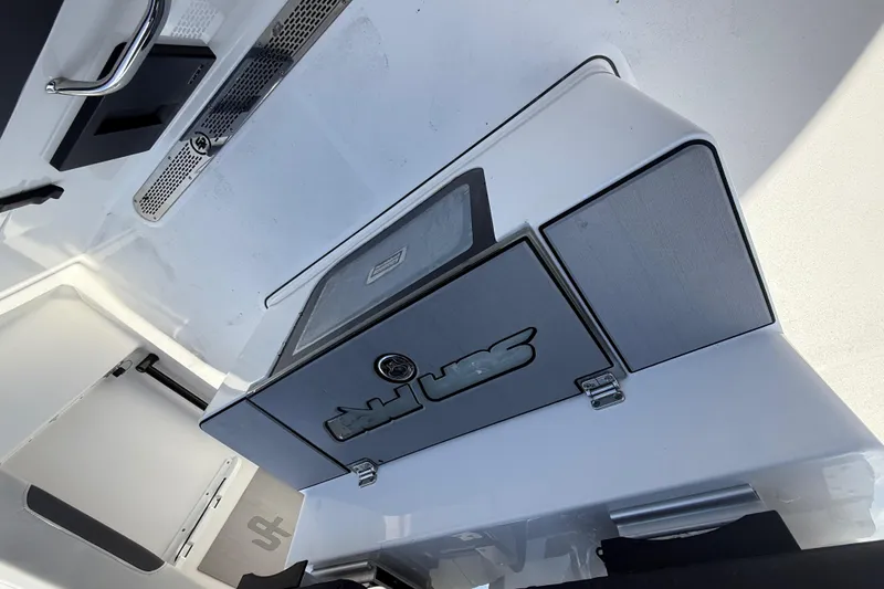 Slide: The Image of 2025 Sea Pro 245FLX Sandbar boat interior with storage compartments and sleek design. - 19