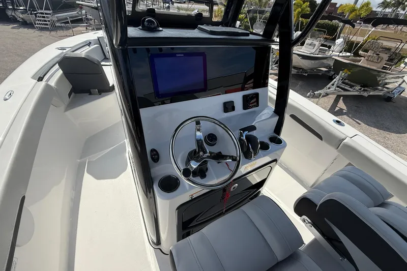 Slide: The Image of 2025 Sea Pro 245FLX Sandbar boat console with steering wheel and navigation screen. - 20