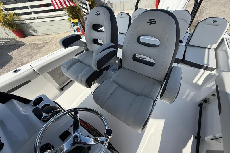 Slide: The Image of 2025 Sea Pro 245FLX Sandbar boat interior with plush seating and modern steering wheel. - 21