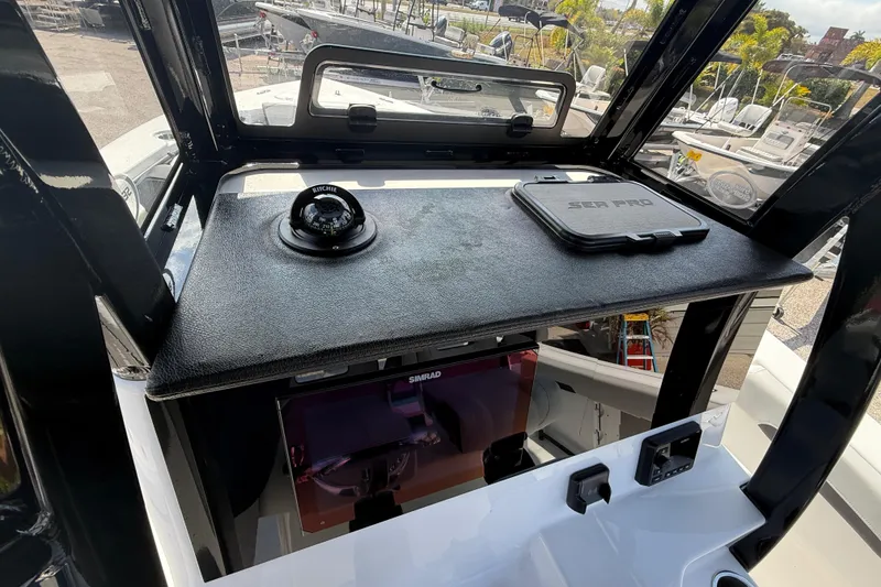 Slide: The Image of 2025 Sea Pro 245FLX Sandbar boat dashboard with compass and Sea Pro cover. - 22