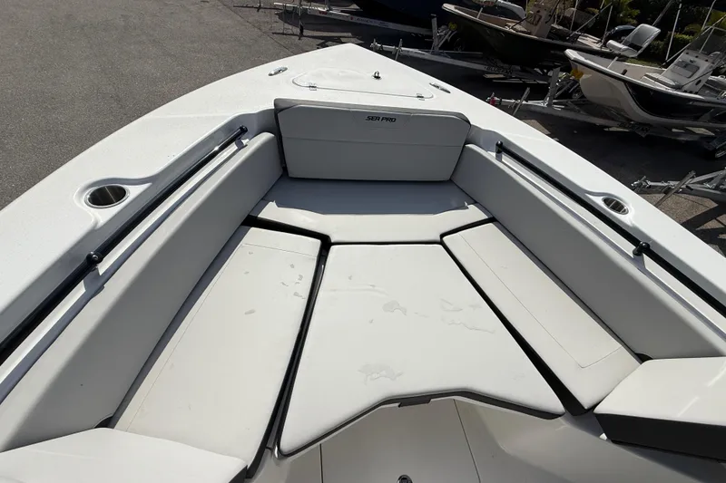 Slide: The Image of 2025 Sea Pro 245FLX Sandbar boat interior with cushioned seating and cup holders. - 24