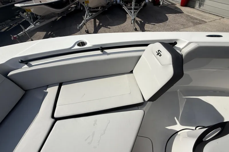 Slide: The Image of 2025 Sea Pro 245FLX Sandbar boat interior with cushioned seating and cup holder. - 26