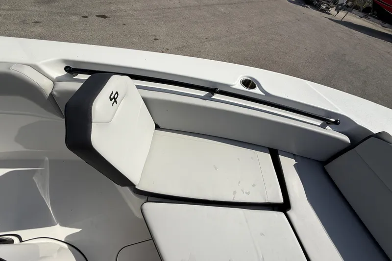 Slide: The Image of 2025 Sea Pro 245FLX Sandbar boat interior with cushioned seating and sleek design. - 27