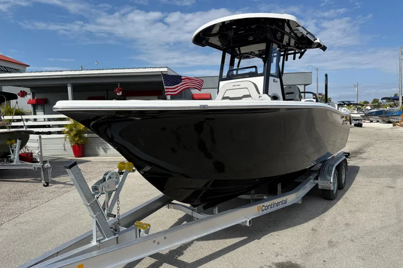 Slide: The Image of 2025 Sea Pro 245FLX Sandbar boat on trailer, displayed outdoors. - 3