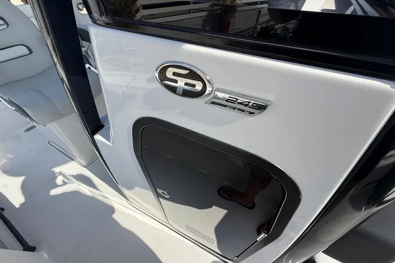 Slide: The Image of 2025 Sea Pro 245FLX Sandbar boat interior with logo and storage compartment. - 30