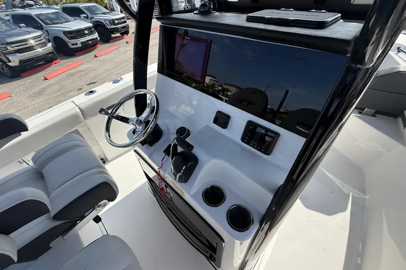 Slide: The Image of 2025 Sea Pro 245FLX Sandbar boat console with steering wheel and controls. - 32