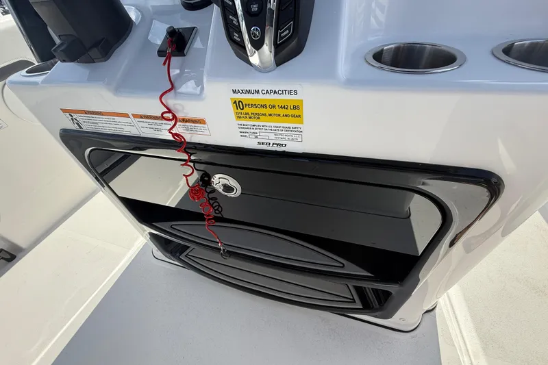 Slide: The Image of 2025 Sea Pro 245FLX Sandbar boat console with capacity warning and cup holders. - 38