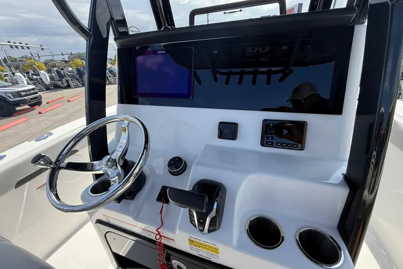 Slide: The Image of 2025 Sea Pro 245FLX Sandbar boat dashboard with steering wheel and controls. - 39