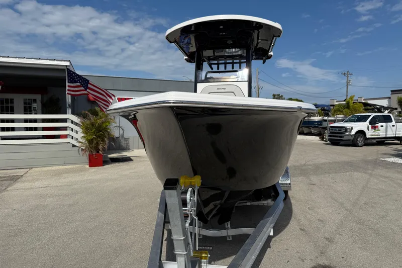 Slide: The Image of 2025 Sea Pro 245FLX Sandbar boat on trailer, outdoor dealership setting. - 4