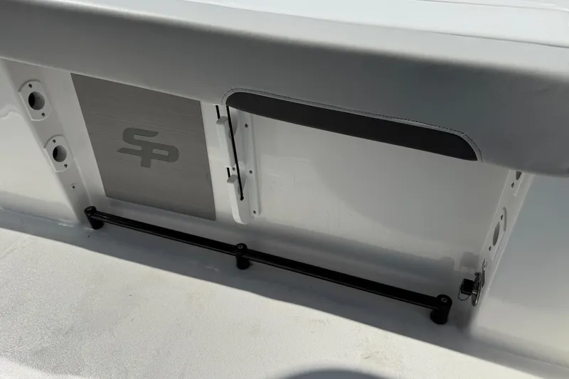 Slide: The Image of 2025 Sea Pro 245FLX Sandbar boat interior detail with logo and storage compartment. - 42