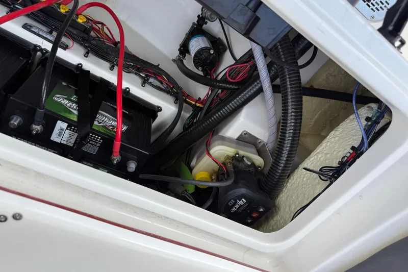 Slide: The Image of 2025 Sea Pro 245FLX Sandbar boat battery compartment with wiring and components. - 44