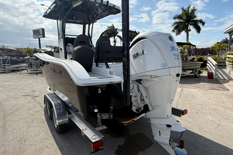 Slide: The Image of 2025 Sea Pro 245FLX Sandbar boat with Yamaha engine on trailer, parked outdoors. - 9