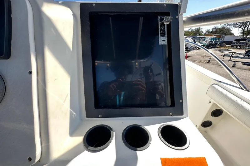 Slide: The Image of 1993 Hydra-Sports Bay Bolt 1900 boat dashboard with cup holders and a screen. - 24