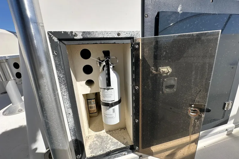Slide: The Image of Open storage compartment on 1993 Hydra-Sports Bay Bolt 1900 boat with fire extinguisher. - 33