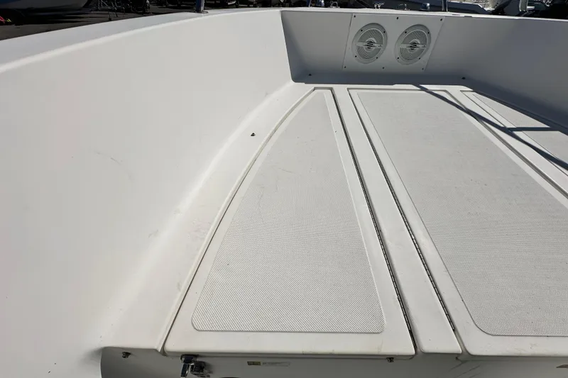 Slide: The Image of 1993 Hydra-Sports Bay Bolt 1900 boat deck with storage compartments and speakers. - 38