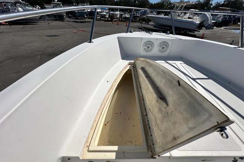 Slide: The Image of 1993 Hydra-Sports Bay Bolt 1900 boat with open storage compartment, docked among other boats. - 39