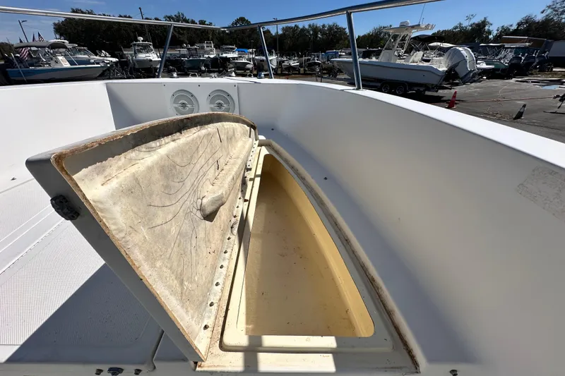 Slide: The Image of 1993 Hydra-Sports Bay Bolt 1900 boat with open storage compartment, docked among other boats. - 43