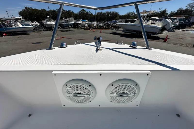 Slide: The Image of 1993 Hydra-Sports Bay Bolt 1900 boat with dual speakers, docked in a marina. - 45
