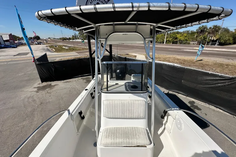 Slide: The Image of 1993 Hydra-Sports Bay Bolt 1900 boat with T-top and seating, parked outdoors. - 50