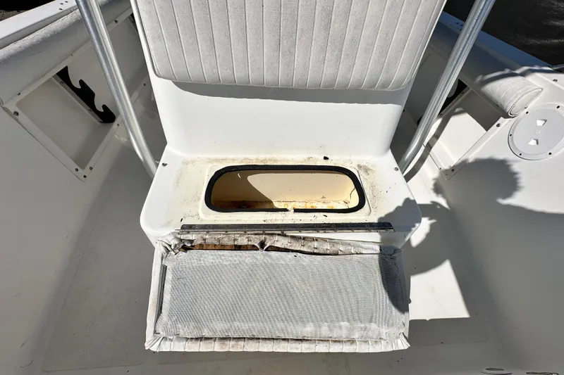 Slide: The Image of 1993 Hydra-Sports Bay Bolt 1900 boat seat with storage compartment, open and weathered. - 52