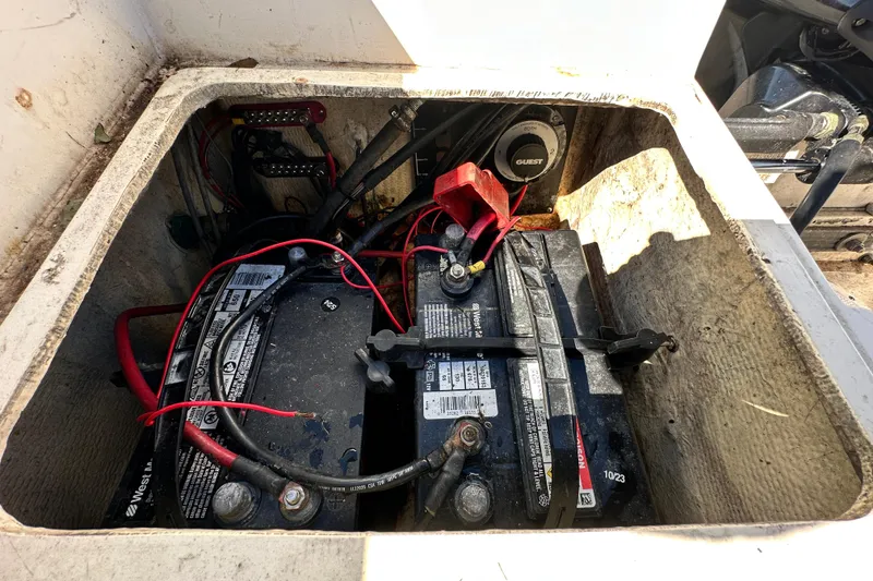 Slide: The Image of Battery compartment of a 1993 Hydra-Sports Bay Bolt 1900 boat with wiring and connections. - 59