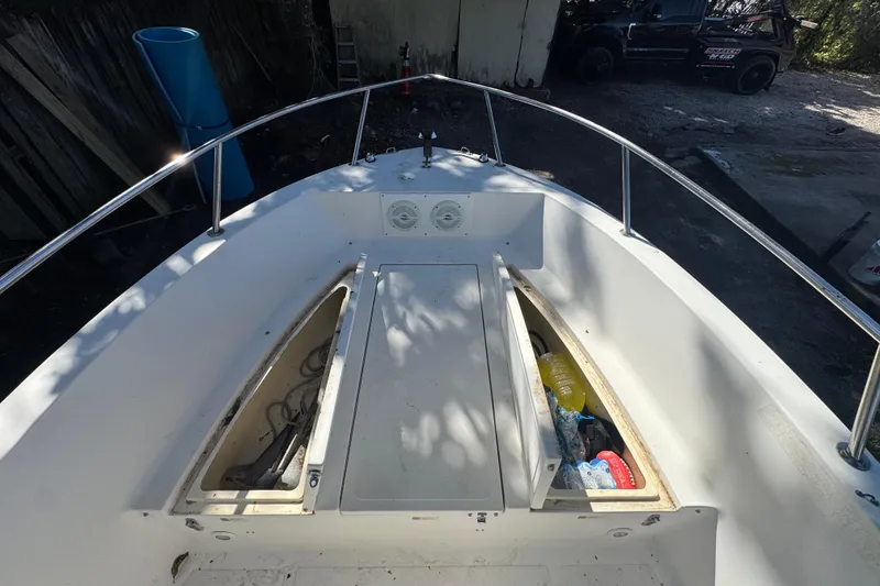 Slide: The Image of 1993 Hydra-Sports Bay Bolt 1900 boat with Mercury outboard motor, parked on a trailer. - 6