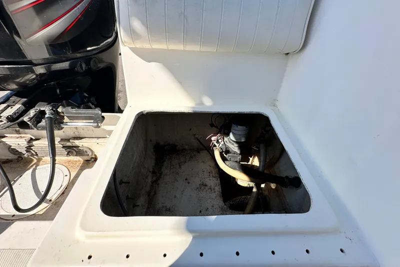 Slide: The Image of 1993 Hydra-Sports Bay Bolt 1900 boat compartment with visible engine components. - 62