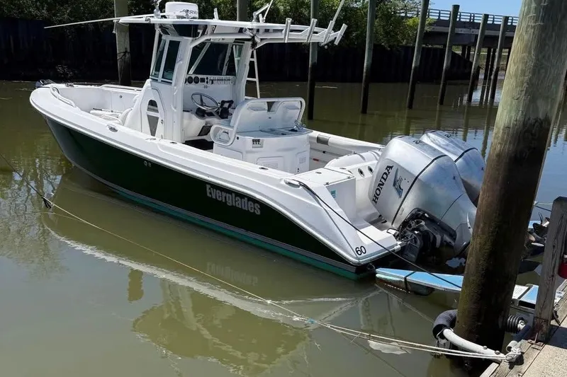 Slide: The Image of 2006 Everglades 260 Center Console boat docked with dual Honda outboard engines. - 1