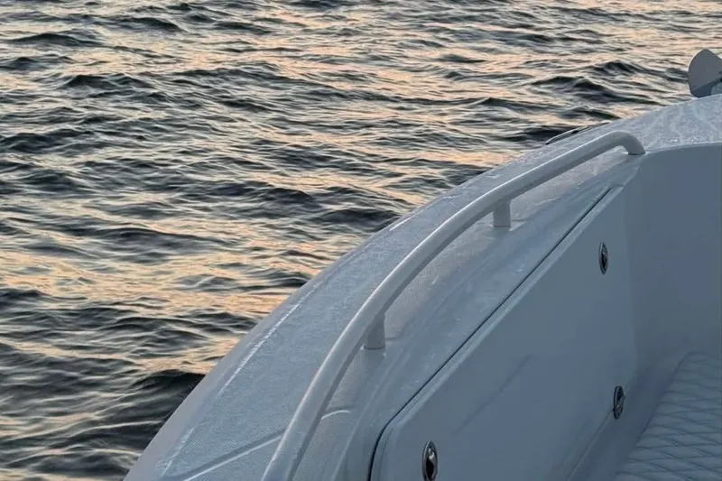 Slide: The Image of 2006 Everglades 260 Center Console boat on calm water at sunset. - 10