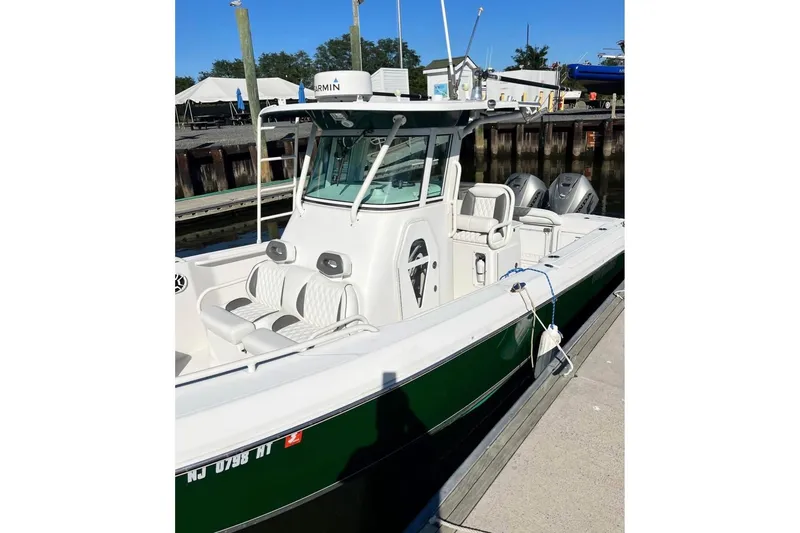 Slide: The Image of 2006 Everglades 260 Center Console boat docked, featuring dual engines and modern design. - 3