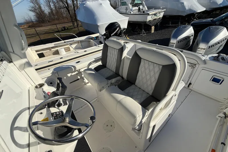 Slide: The Image of 2006 Everglades 260 Center Console boat interior with dual seats and steering wheel. - 6