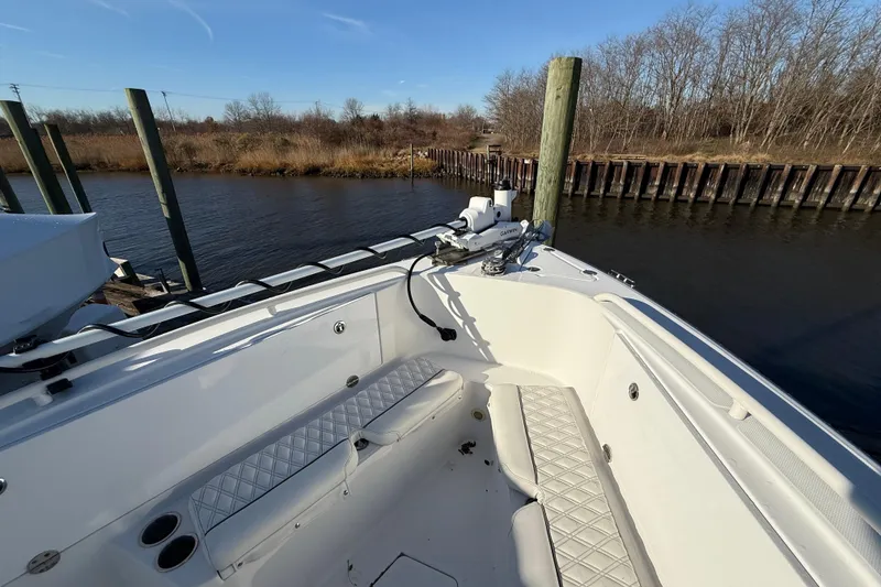 Slide: The Image of 2006 Everglades 260 Center Console boat docked by a calm riverbank. - 7