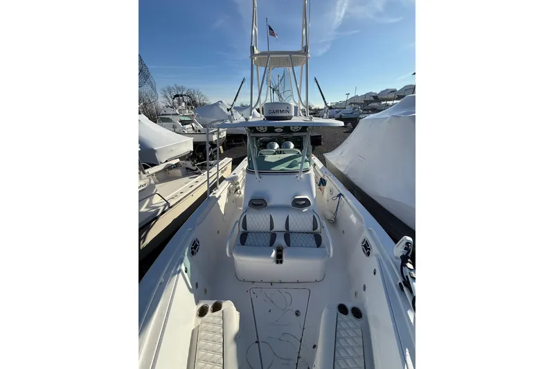 Slide: The Image of 2006 Everglades 260 Center Console boat with seating and navigation equipment, docked outdoors. - 8