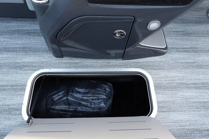 Slide: The Image of 2026 Bennington M Swingback 22 MSB storage compartment with open hatch on boat deck. - 18