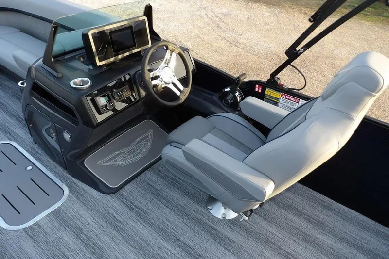 Slide: The Image of 2026 Bennington M Swingback 22 MSB boat interior with modern helm and comfortable seating. - 20
