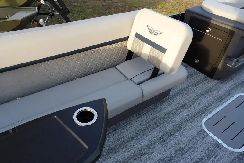 Slide: The Image of 2026 Bennington M Swingback 22 MSB boat interior with gray seating and cup holder. - 22