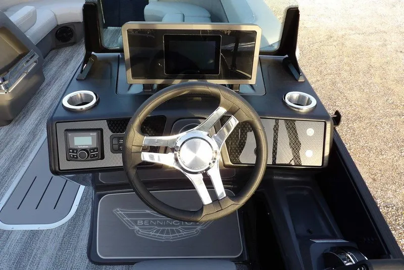 Slide: The Image of 2026 Bennington M Swingback 22 MSB boat dashboard with steering wheel and digital display. - 23
