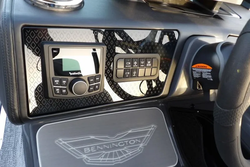 Slide: The Image of 2026 Bennington M Swingback 22 MSB dashboard with control panel and Rockford Fosgate audio system. - 25