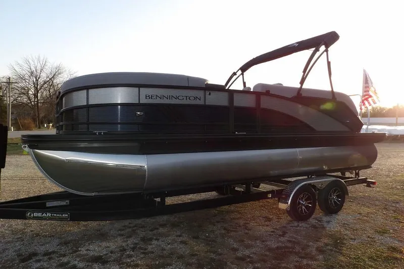 Slide: The Image of 2026 Bennington M Swingback 22 MSB pontoon boat on trailer at sunset. - 4