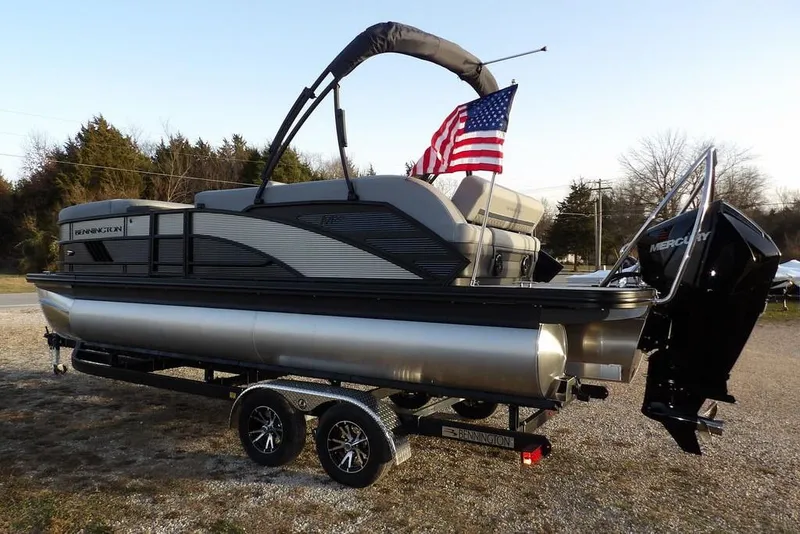 Slide: The Image of 2026 Bennington M Swingback 22 MSB pontoon boat on trailer with American flag. - 6