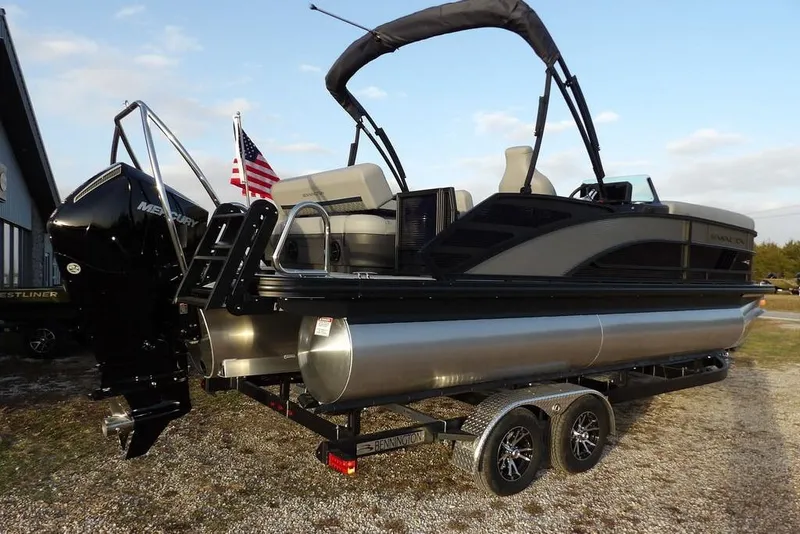 Slide: The Image of 2026 Bennington M Swingback 22 MSB pontoon boat on trailer, featuring Mercury engine. - 7