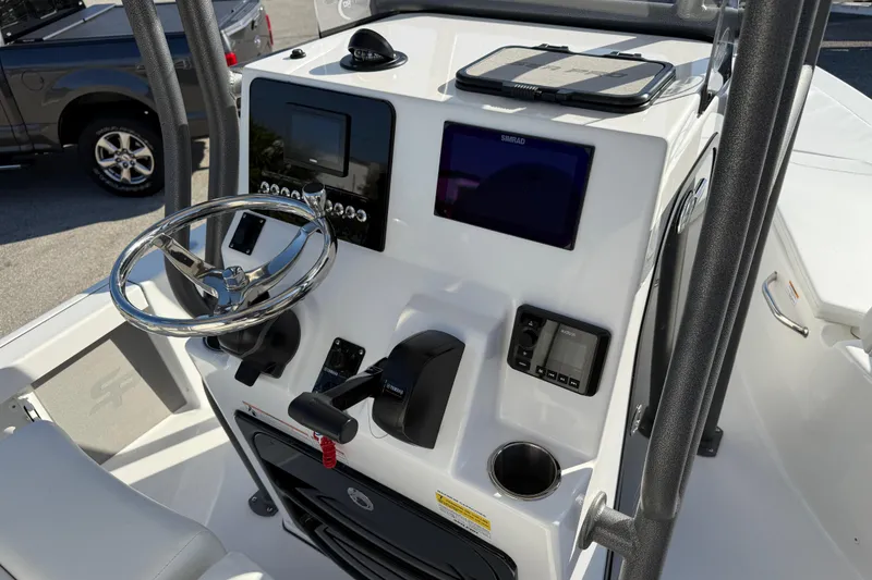 Slide: The Image of 2025 Sea Pro 210 Bay boat with outboard motor and seating area. - 13