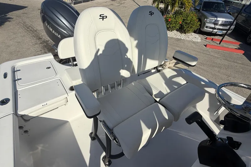 Slide: The Image of 2025 Sea Pro 210 Bay boat dashboard with steering wheel and controls. - 15