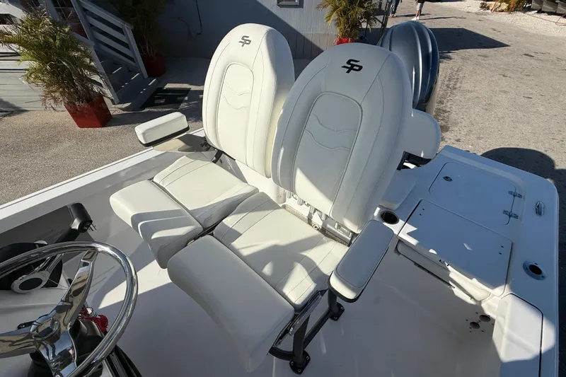 Slide: The Image of 2025 Sea Pro 210 Bay boat interior with cushioned seating and cup holders. - 17