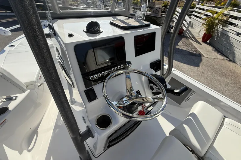 Slide: The Image of 2025 Sea Pro 210 Bay boat interior with white seating and trolling motor. - 18