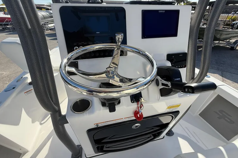 Slide: The Image of 2025 Sea Pro 210 Bay boat interior with white seating and trolling motor. - 19