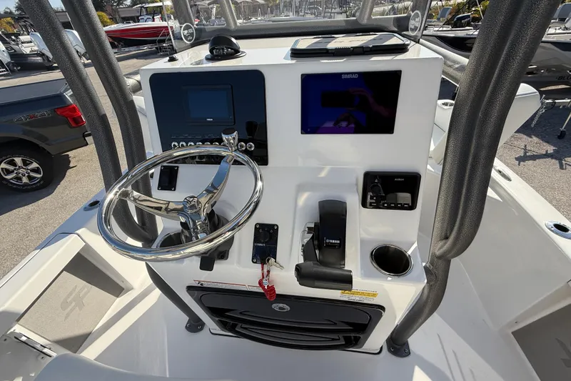 Slide: The Image of Livewell compartment on a 2025 Sea Pro 210 Bay boat, open lid view. - 27