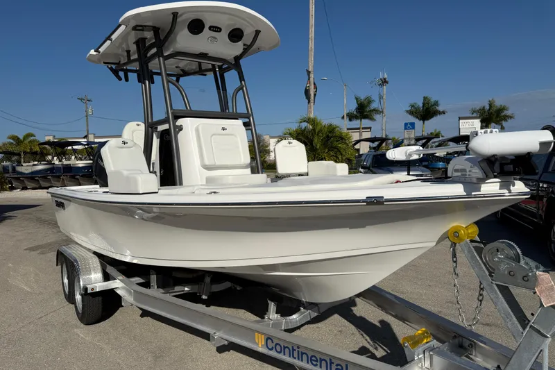 Slide: The Image of 2025 Sea Pro 210 Bay boat with Yamaha engine on a trailer in a parking lot. - 5