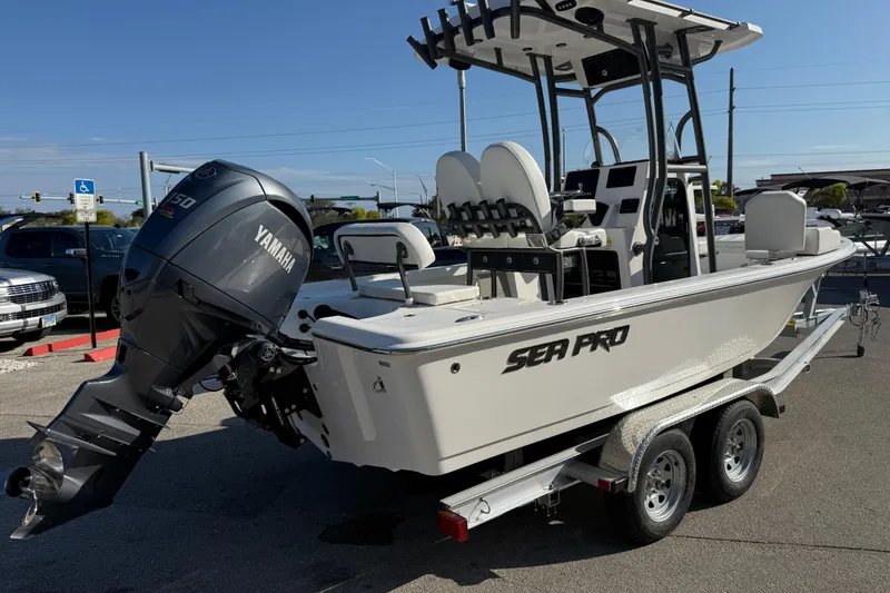 Slide: The Image of 2025 Sea Pro 210 Bay boat with Yamaha engine on trailer, parked outdoors. - 7